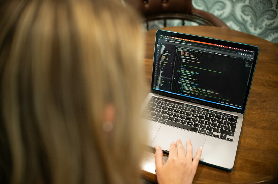 beginner coder working on laptop