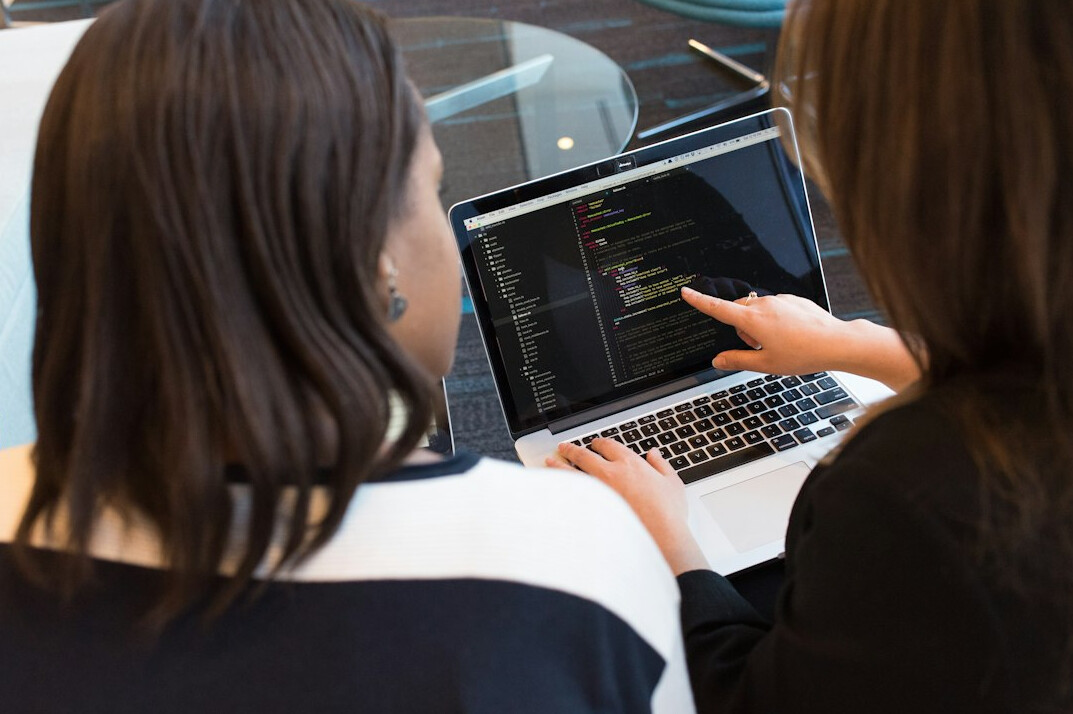 man teaching coding to students