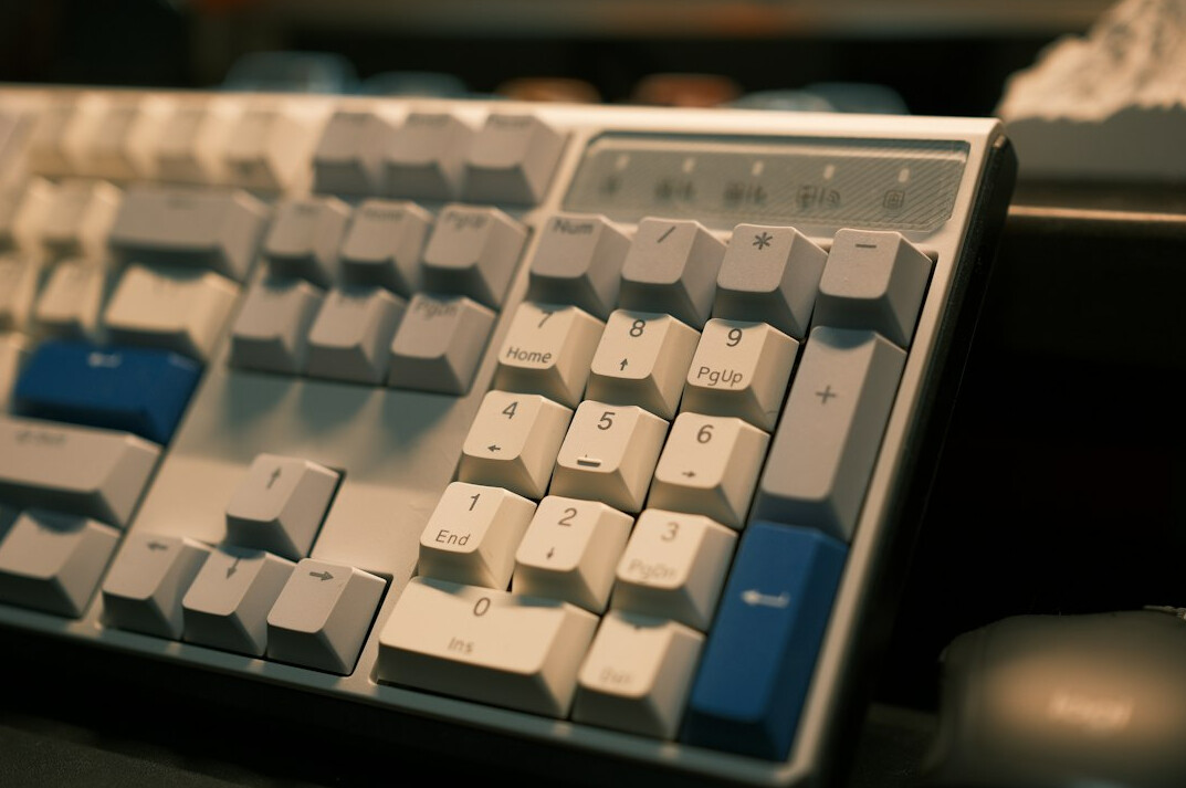 Close-up of hands typing on a mechanical keyboard