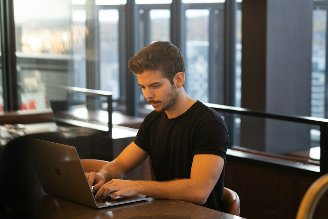 programmer typing on laptop
