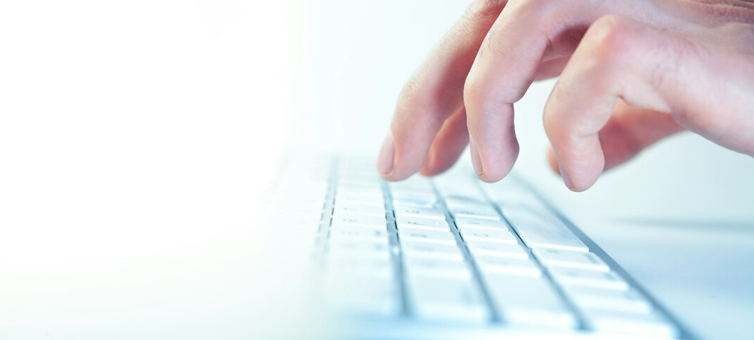 hands typing on keyboard